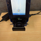 Small screen displaying a 'Close' button on a wooden surface with electronic components.