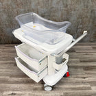Side angle of Stryker hospital baby bassinet with wheels - for sale