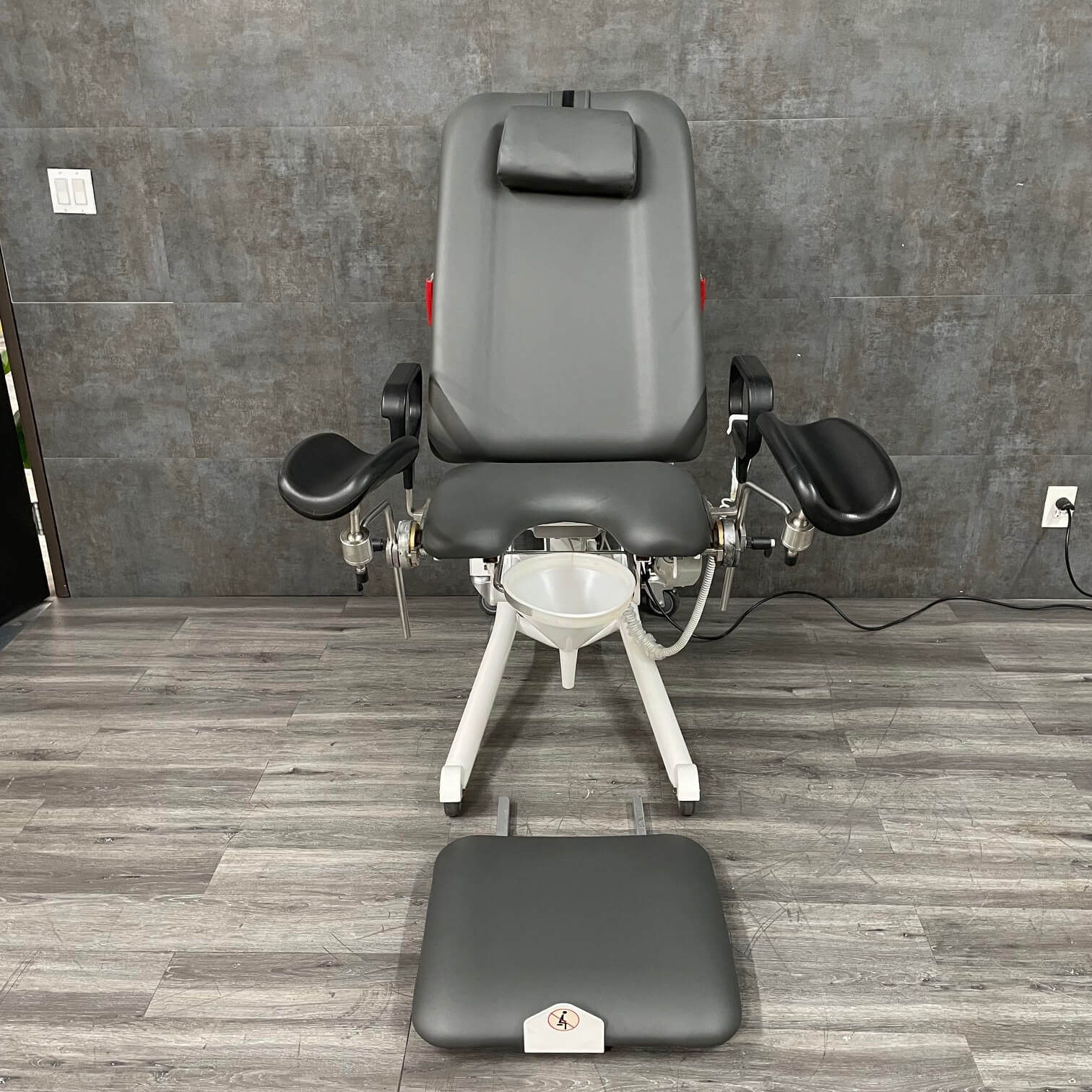 Refurbished Urology Chair with hand control shown with stirrups