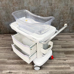 Side angle of Stryker hospital baby bassinet with wheels - for sale