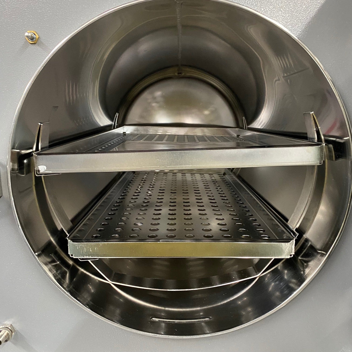 Large stainless steel chamber inside Tuttnauer 3870EA autoclave with instrument trays - For Sale Near me